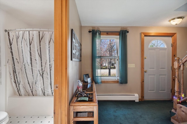 carpeted foyer with baseboard heating