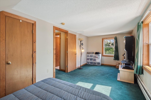carpeted bedroom featuring a textured ceiling, baseboards, and a baseboard radiator