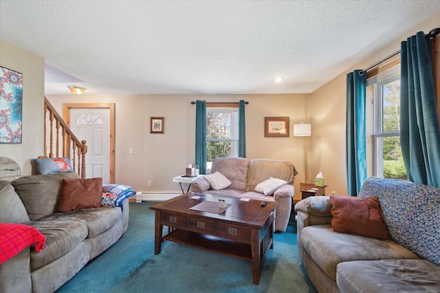 living area with carpet flooring, a textured ceiling, stairs, and a baseboard radiator
