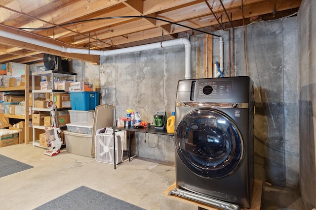 unfinished below grade area featuring washer / dryer