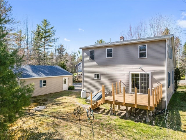 back of property featuring a chimney and a deck