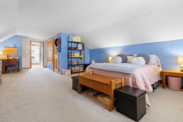 carpeted bedroom featuring baseboards, a textured ceiling, and lofted ceiling