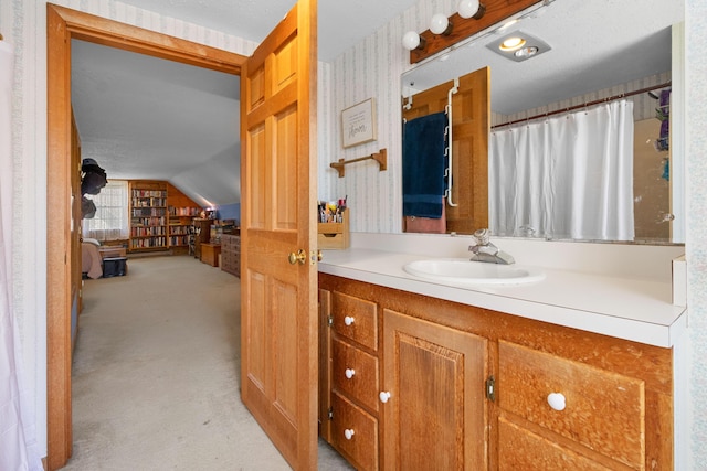 full bathroom featuring vanity and lofted ceiling