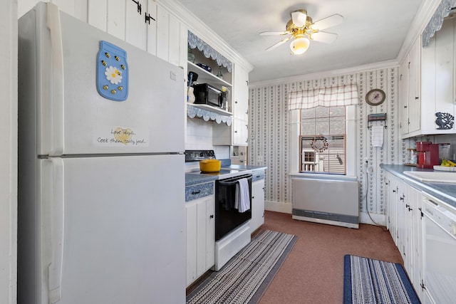 kitchen featuring white cabinets, ceiling fan, white appliances, dark carpet, and ornamental molding