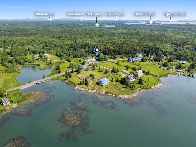 aerial view with a water view and a wooded view