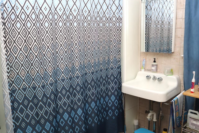 12 Sherwin St, Waterville, ME 04901 - bathroom with a sink, a shower with shower curtain, and tile walls