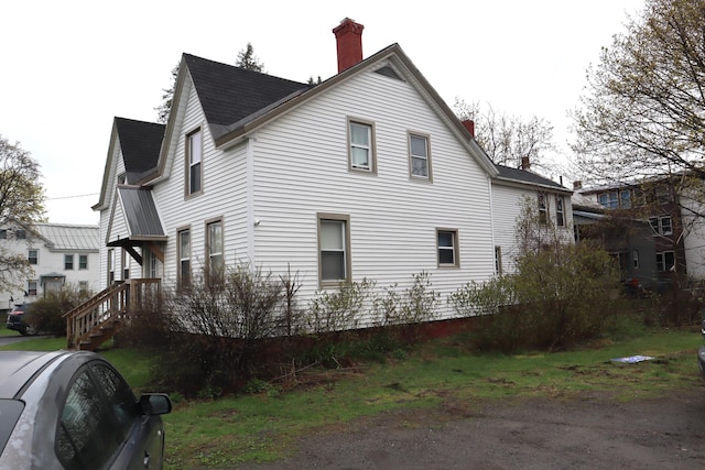 12 Sherwin St, Waterville, ME 04901 - view of side of property featuring a shingled roof and a chimney