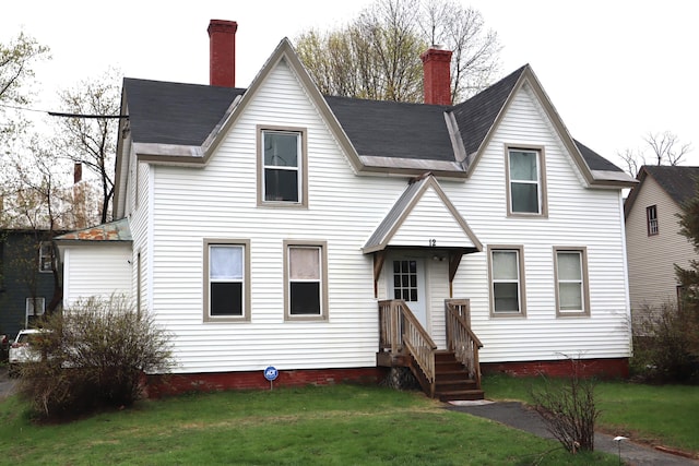 12 Sherwin St, Waterville, ME 04901 - view of front facade with a chimney and a front lawn