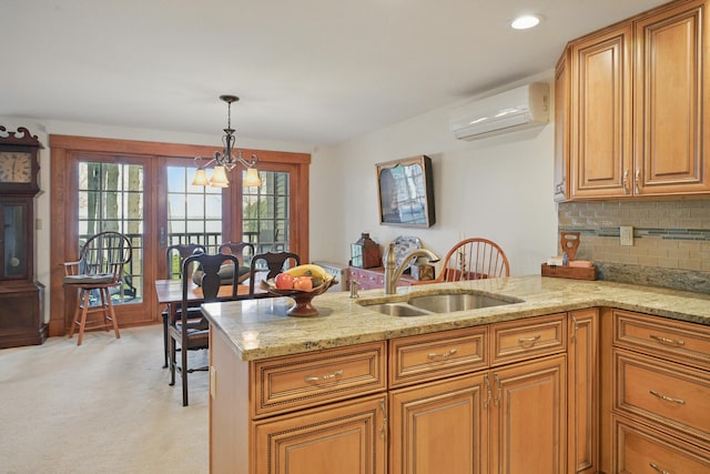 39 Turtle Run Rd Unit 8, Winthrop, ME 04364 - kitchen with a sink, a peninsula, a wall mounted air conditioner, light stone counters, and plenty of natural light