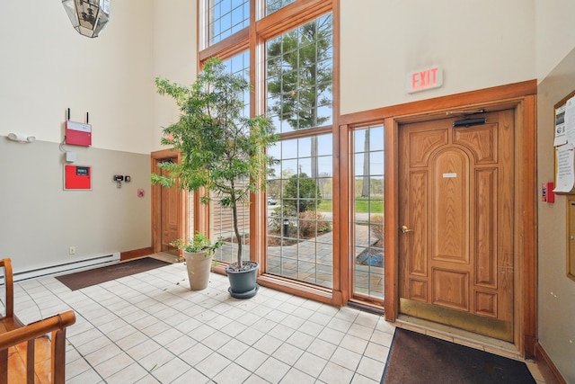 39 Turtle Run Rd Unit 8, Winthrop, ME 04364 - doorway with a towering ceiling, light tile patterned floors, and baseboard heating