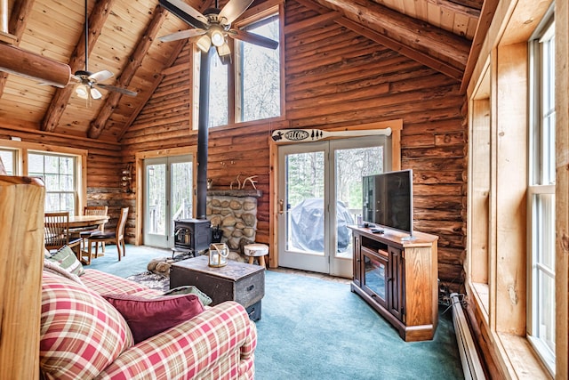 26 Mountain View Ln, Woodstock, ME 04219 - living area with a ceiling fan, rustic walls, wood ceiling, beamed ceiling, and a wood stove