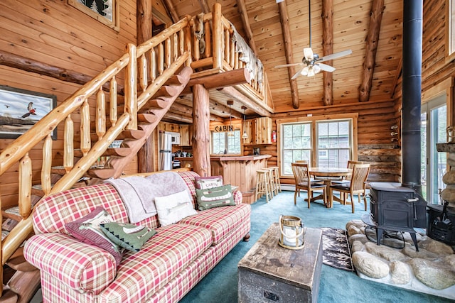 26 Mountain View Ln, Woodstock, ME 04219 - carpeted living room with wood ceiling, a ceiling fan, stairway, beamed ceiling, and a wood stove