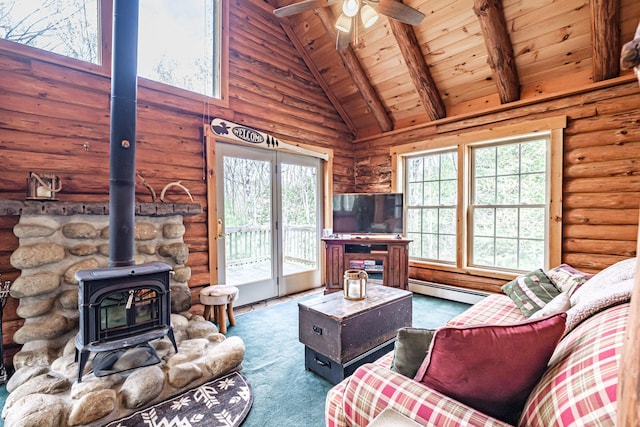 26 Mountain View Ln, Woodstock, ME 04219 - living area with beam ceiling, a wood stove, a baseboard radiator, a ceiling fan, and wood ceiling