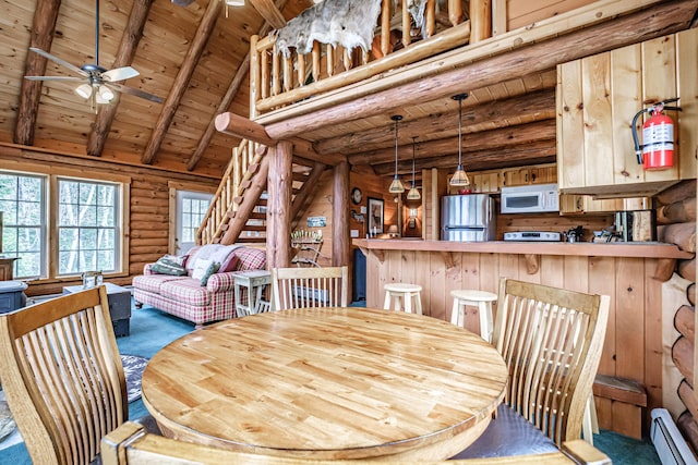 26 Mountain View Ln, Woodstock, ME 04219 - dining room featuring beamed ceiling, baseboard heating, log walls, and wood ceiling