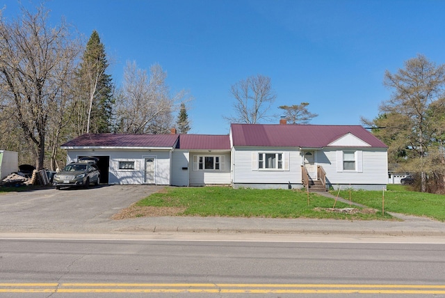 232 Peltoma Ave, Pittsfield, ME 04967 - ranch-style house featuring a garage, metal roof, a front yard, entry steps, and asphalt driveway