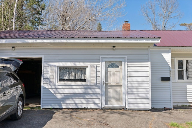 232 Peltoma Ave, Pittsfield, ME 04967 - view of front of house with metal roof and a chimney