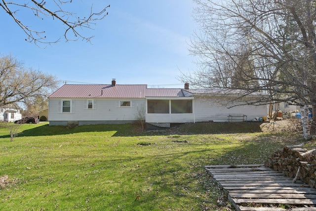 232 Peltoma Ave, Pittsfield, ME 04967 - rear view of house with a chimney, metal roof, and a yard