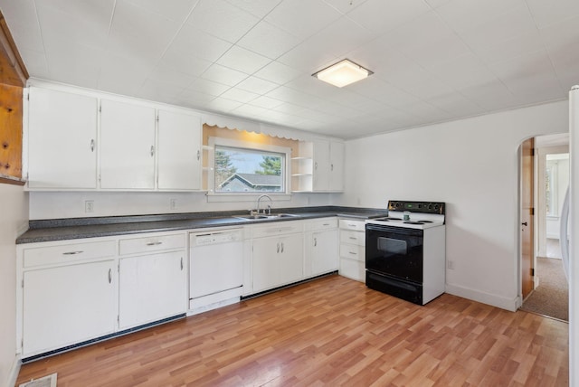 232 Peltoma Ave, Pittsfield, ME 04967 - kitchen with electric range, white dishwasher, a sink, dark countertops, and arched walkways
