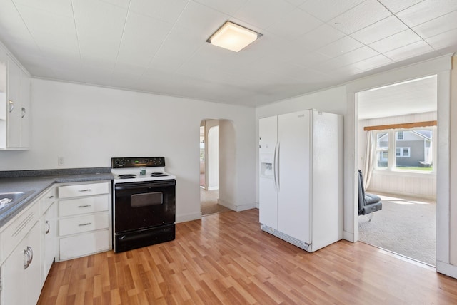 232 Peltoma Ave, Pittsfield, ME 04967 - kitchen with range with electric cooktop, white fridge with ice dispenser, arched walkways, white cabinetry, and light wood-type flooring