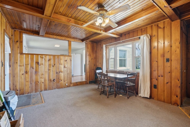 232 Peltoma Ave, Pittsfield, ME 04967 - carpeted dining space featuring wood walls, wood ceiling, ceiling fan, and beamed ceiling