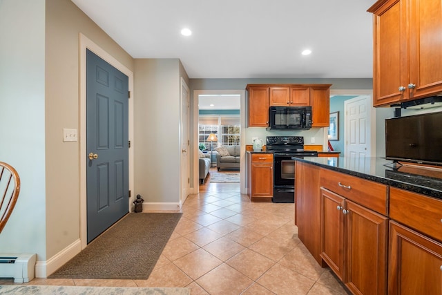 kitchen with baseboard heating, baseboards, brown cabinetry, light tile patterned flooring, and black appliances