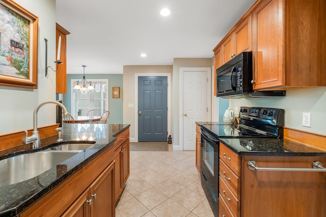 kitchen with brown cabinetry, light tile patterned floors, an inviting chandelier, a sink, and black appliances