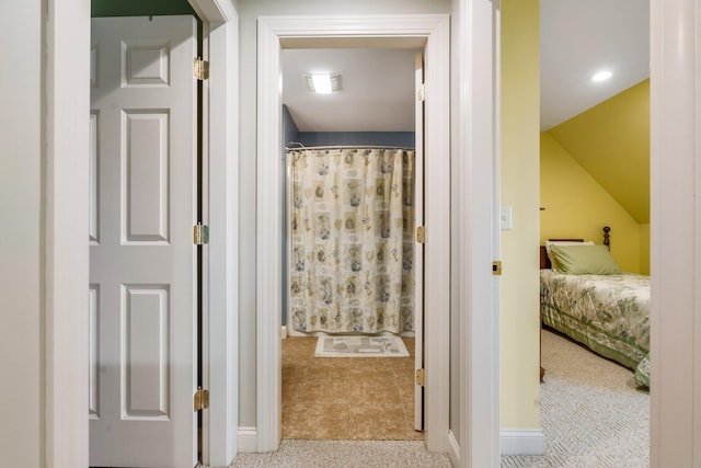 full bathroom with baseboards, lofted ceiling, and curtained shower