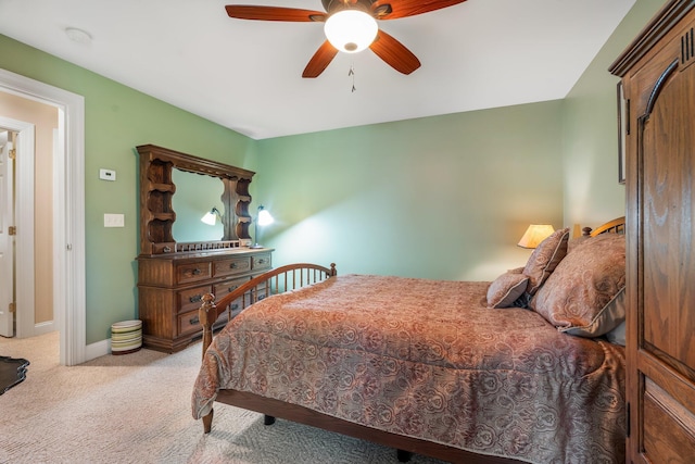 carpeted bedroom with baseboards and a ceiling fan