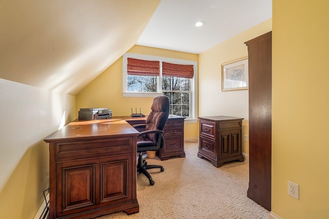 office space with vaulted ceiling, light colored carpet, and baseboards