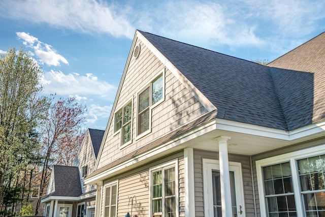 view of home's exterior with roof with shingles