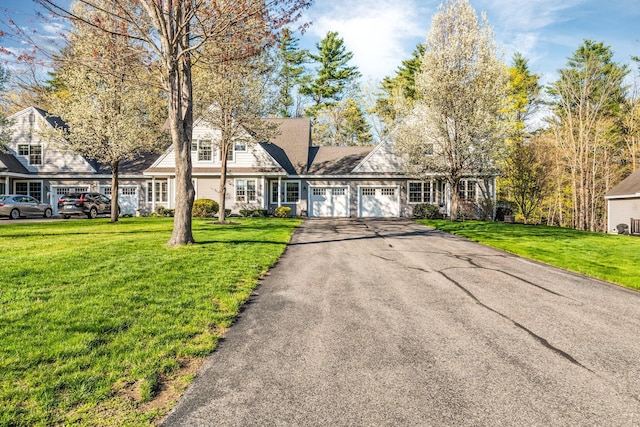 view of front of home with a front yard, a garage, and driveway