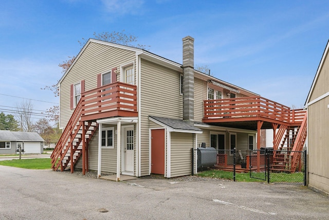 178 Bradley St, Saco, ME 04072 - view of front of property with stairs, fence, a wooden deck, and a chimney