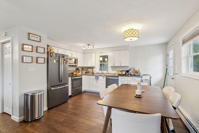 178 Bradley St, Saco, ME 04072 - kitchen with stainless steel appliances, baseboard heating, white cabinets, dark wood-type flooring, and a textured ceiling