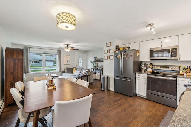 178 Bradley St, Saco, ME 04072 - kitchen featuring appliances with stainless steel finishes, white cabinetry, and dark wood-style flooring