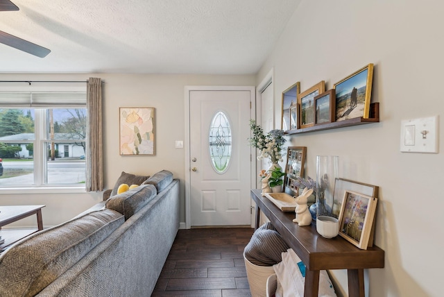 178 Bradley St, Saco, ME 04072 - entryway featuring a textured ceiling, dark wood-style floors, ceiling fan, and baseboards