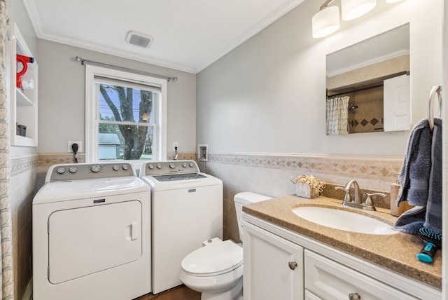 178 Bradley St, Saco, ME 04072 - full bath with separate washer and dryer, tile walls, ornamental molding, wainscoting, and toilet