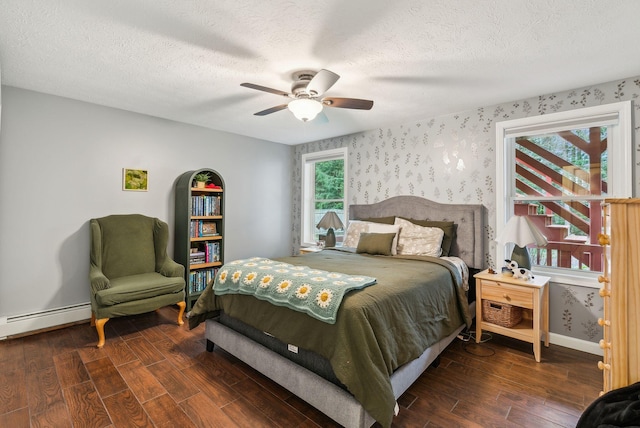 178 Bradley St, Saco, ME 04072 - bedroom featuring wood finished floors, baseboards, baseboard heating, wallpapered walls, and a textured ceiling