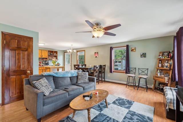 178 Bradley St, Saco, ME 04072 - living area featuring a baseboard heating unit, ceiling fan, light wood-type flooring, a chandelier, and baseboards