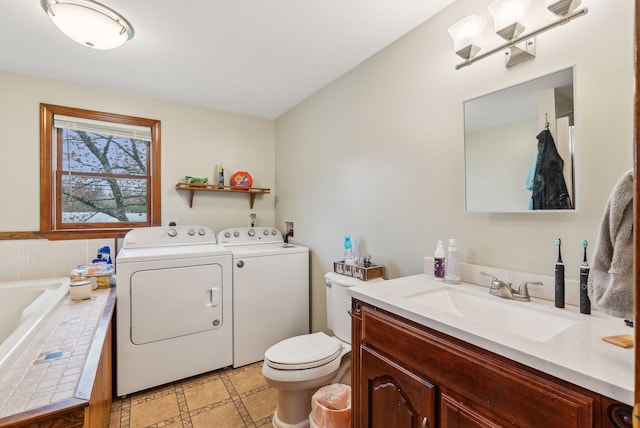 178 Bradley St, Saco, ME 04072 - full bathroom featuring washer and clothes dryer, toilet, vanity, and a tub