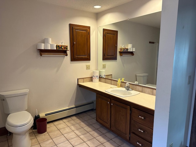 bathroom with a baseboard heating unit, toilet, vanity, and tile patterned flooring