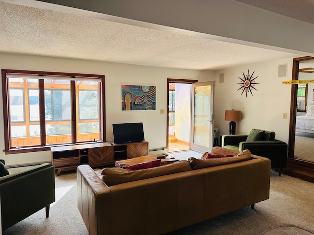living area with light carpet and a textured ceiling