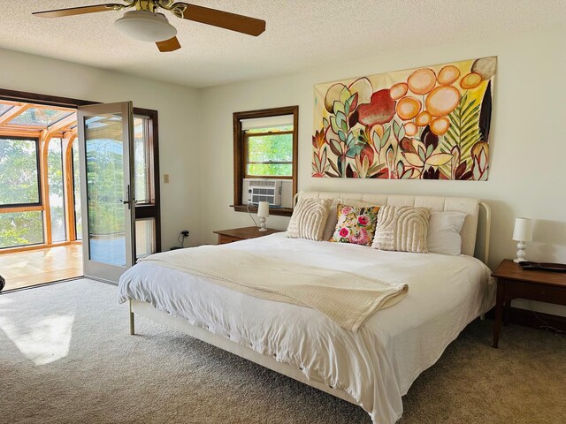 bedroom with carpet flooring, access to exterior, ceiling fan, a textured ceiling, and cooling unit