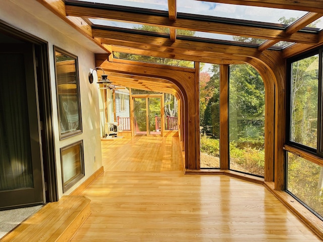 unfurnished sunroom with a skylight