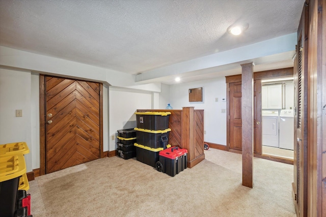 rec room featuring washer and dryer, carpet flooring, a textured ceiling, and baseboards