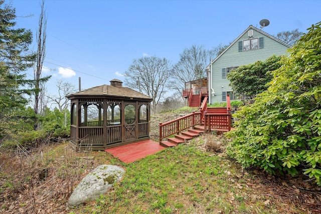 view of yard featuring a gazebo, stairs, and a wooden deck