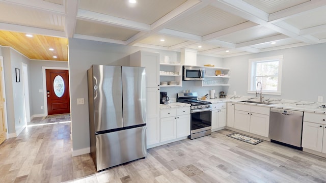 kitchen featuring open shelves, light stone counters, a sink, stainless steel appliances, and coffered ceiling