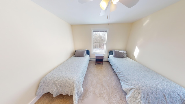 bedroom with a ceiling fan, baseboard heating, and carpet