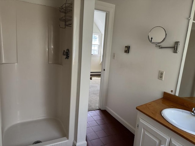 full bath with a walk in shower, tile patterned flooring, vanity, baseboards, and a baseboard radiator