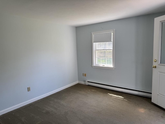 carpeted spare room featuring baseboards and a baseboard heating unit