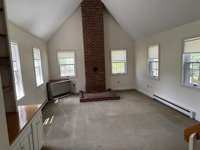 unfurnished living room with carpet floors, baseboards, a baseboard heating unit, and high vaulted ceiling
